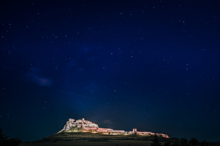 Dark Blue Sky Full Of Stars With A Building Lit Up