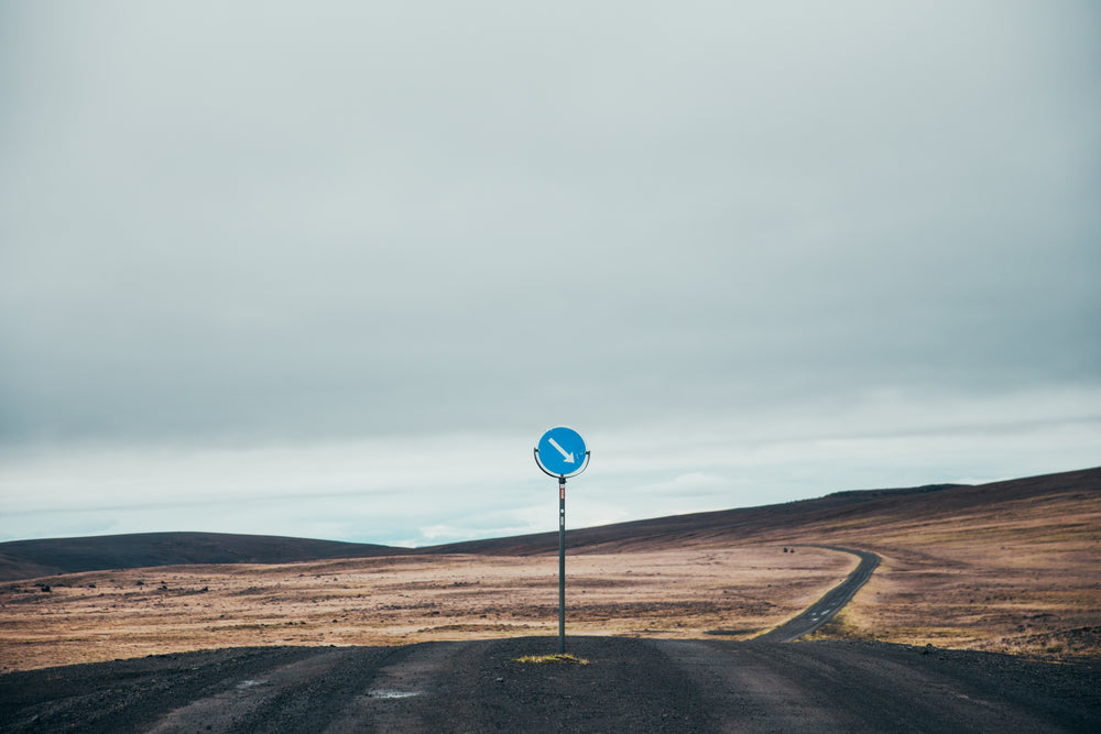 dark dirt road with sign