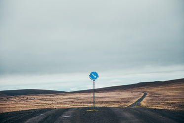 Picture of Dark Dirt Road With Sign — Free Stock Photo