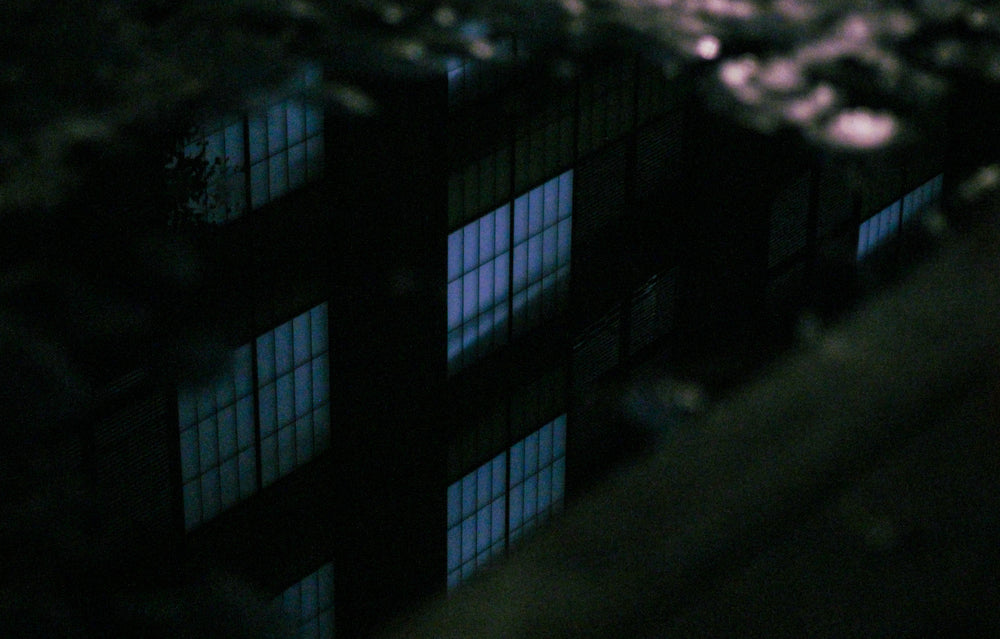 dark photo of a building windows with heavy grain