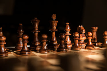 dark wooden chess pieces against a black background