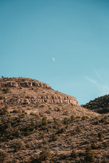 daytime moon and rocks