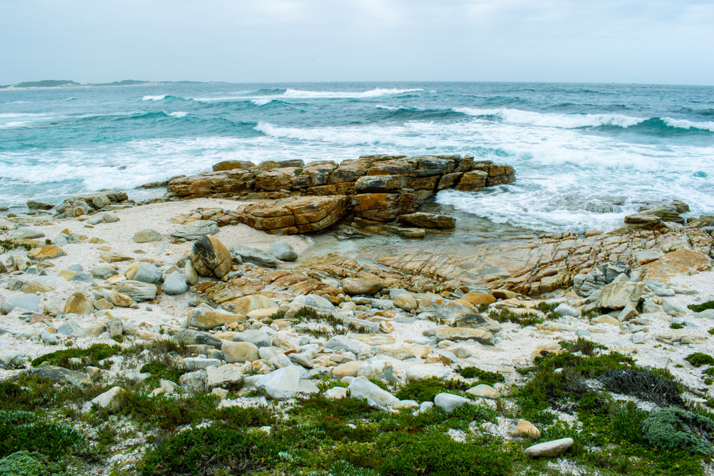 deep blue waves crashing against rocks