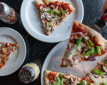 delux pizza slices being served