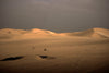 desert sand dunes against a stormy sky