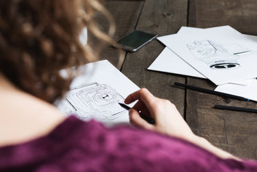 designer or artist working at wooden table