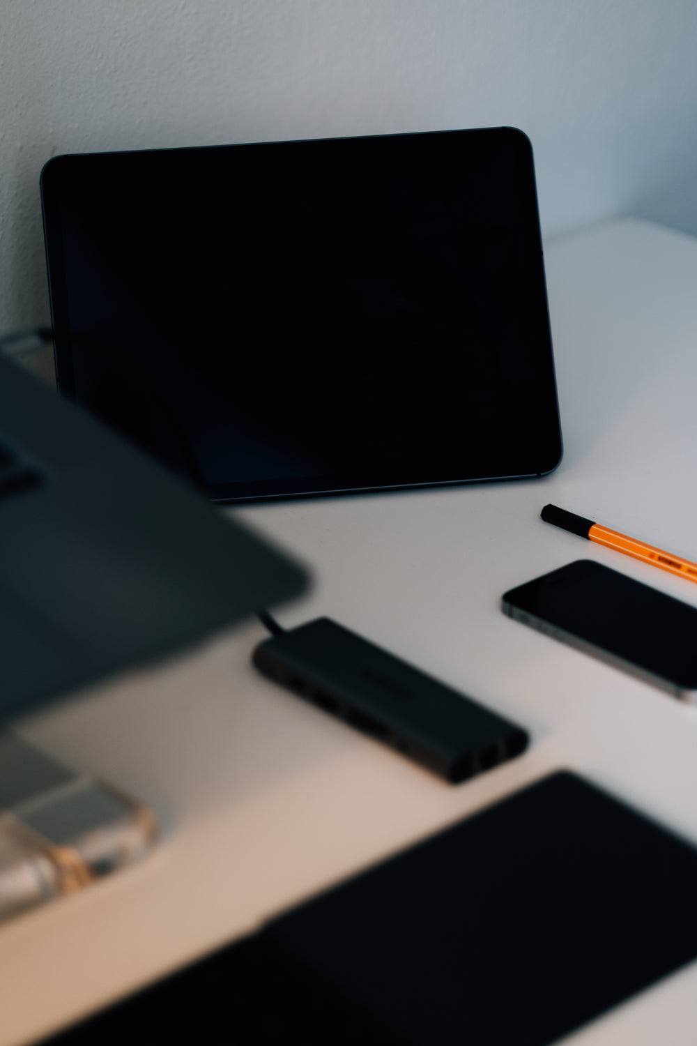 desk with some black gadgets in focus