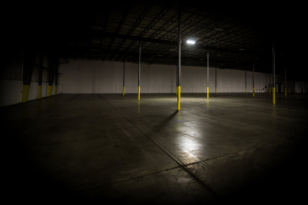 dimly lit empty warehouse