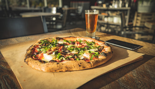 dinner for one of wood fired pizza paired with cold beer