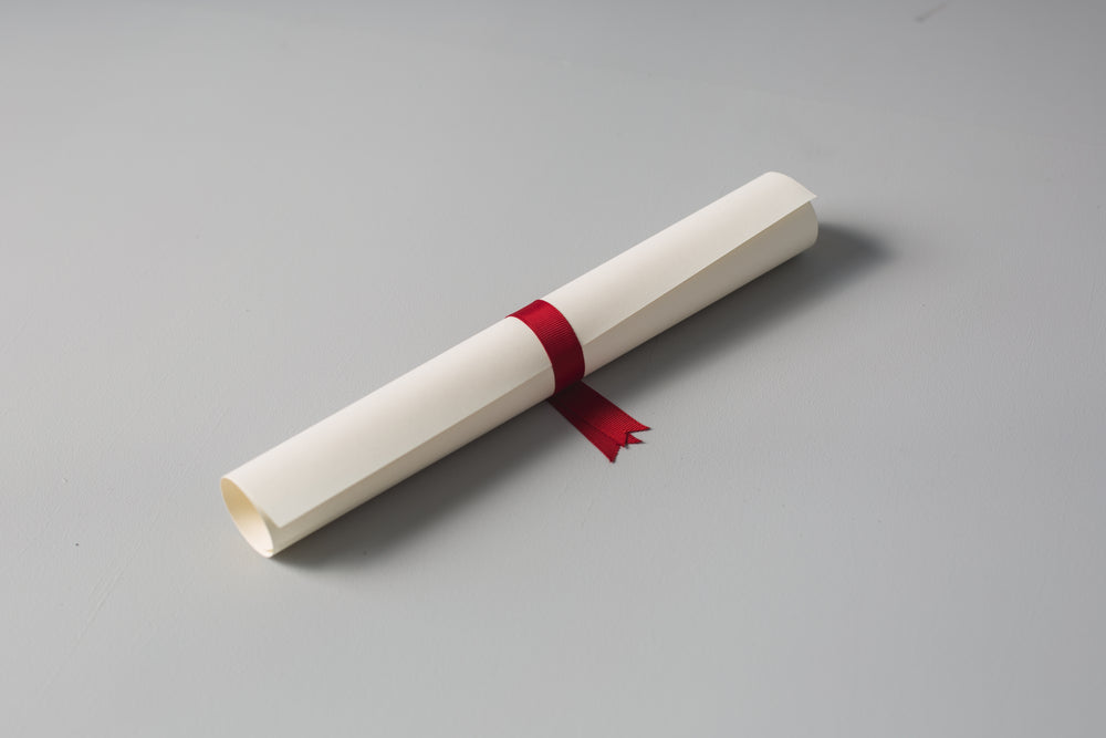 diploma with red ribbon