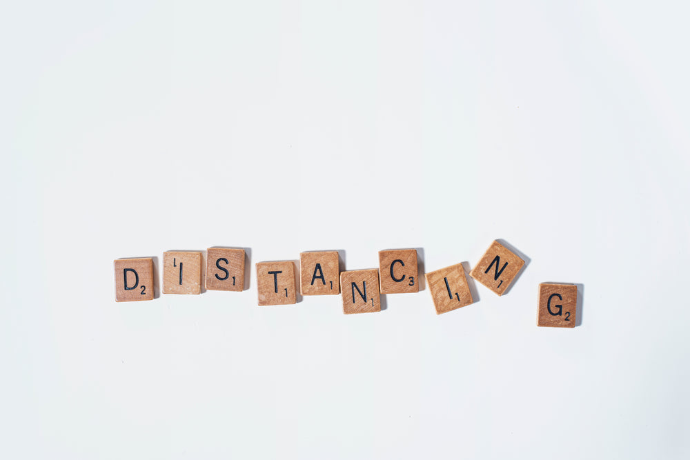 distancing in wooden letter tiles