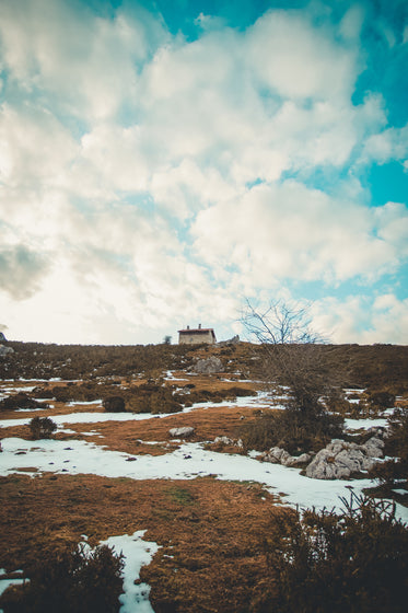 distant house within snowy wilderness