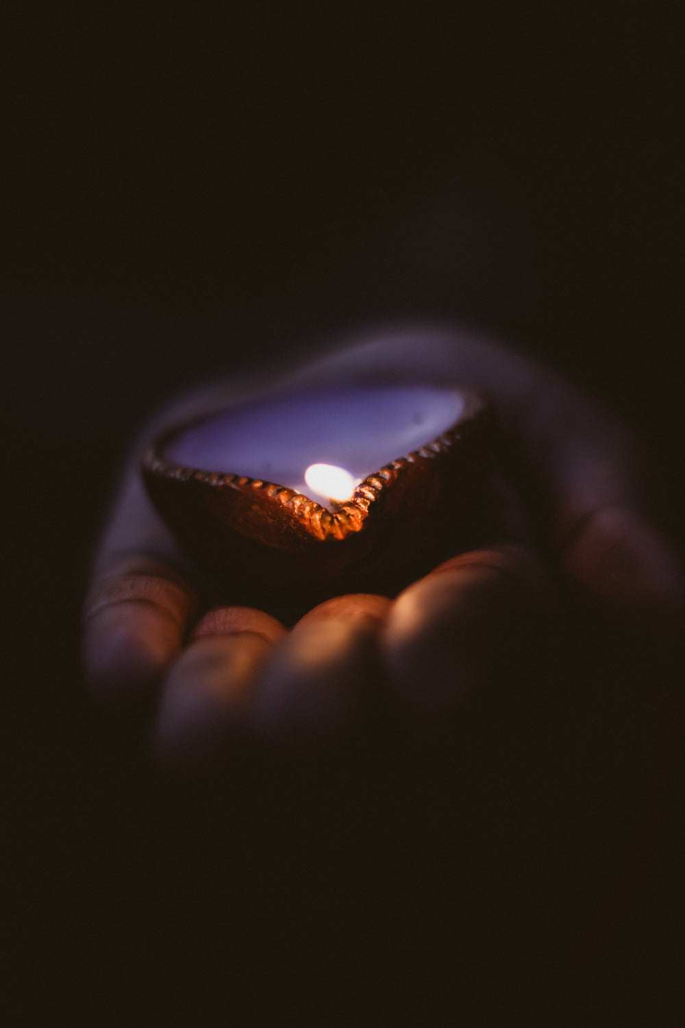 diwali candle lies in the palm of a hand