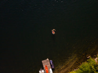 dock by lake with vacationers aerial