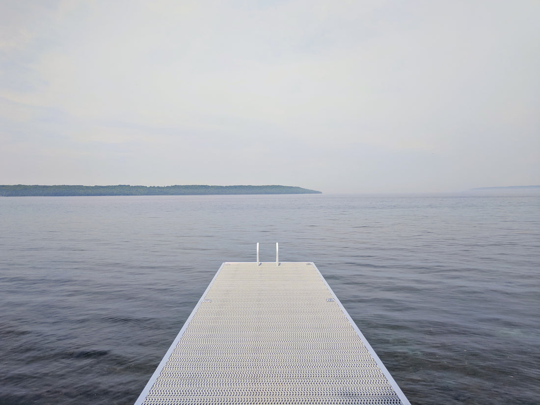 A wooden dock reaching out over calm water
