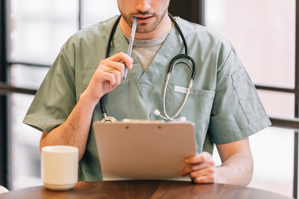 doctor looking at clipboard