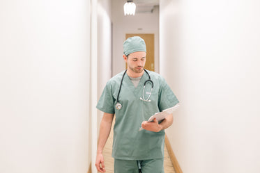 doctor walking down hallway with clipboard