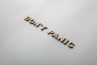don't panic in wooden letters