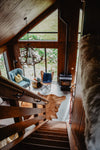 down the stairs of a wooden cabin