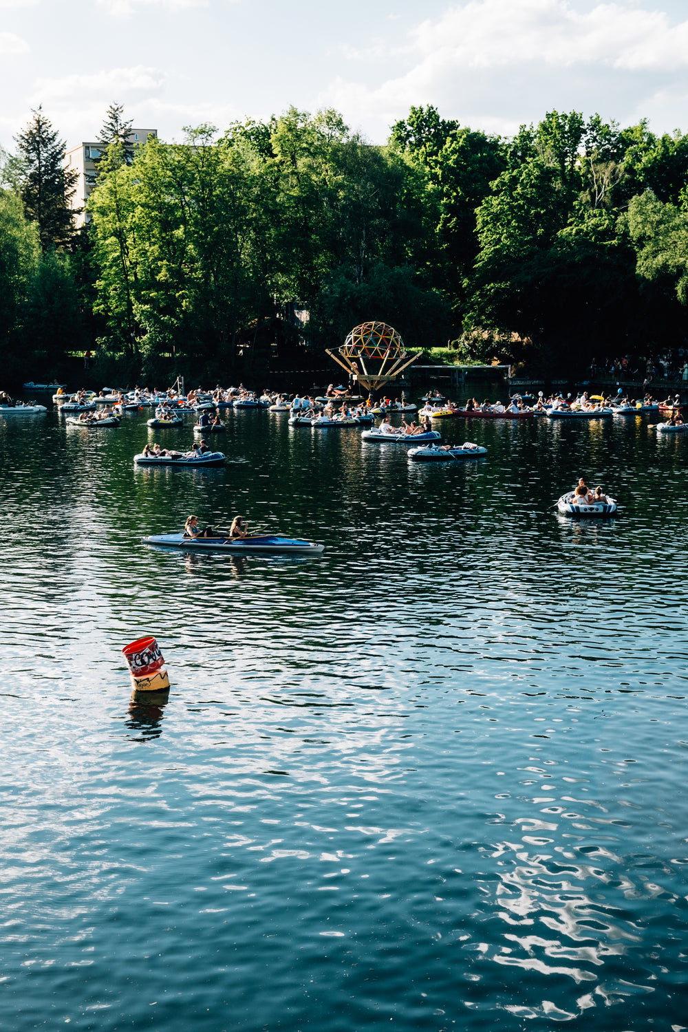 dozens boats and a kayak on the water