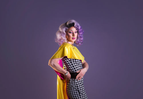 drag performer with purple wig twists