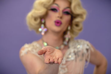 drag queen blowing a kiss only hand in focus