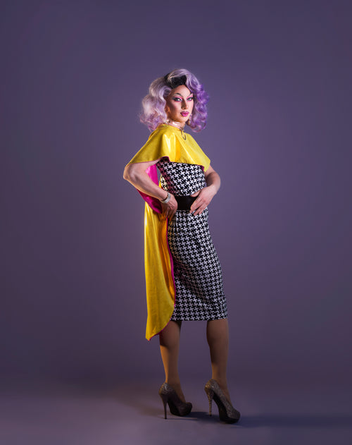 drag queen poses in professional outift