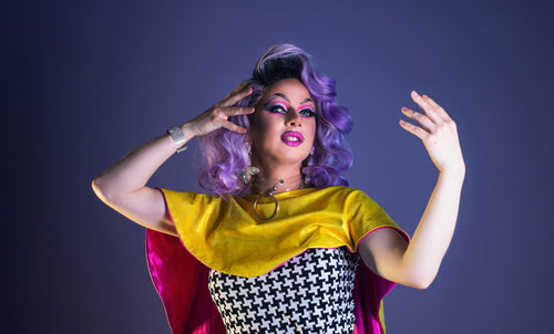 drag queen runs fingers through wig