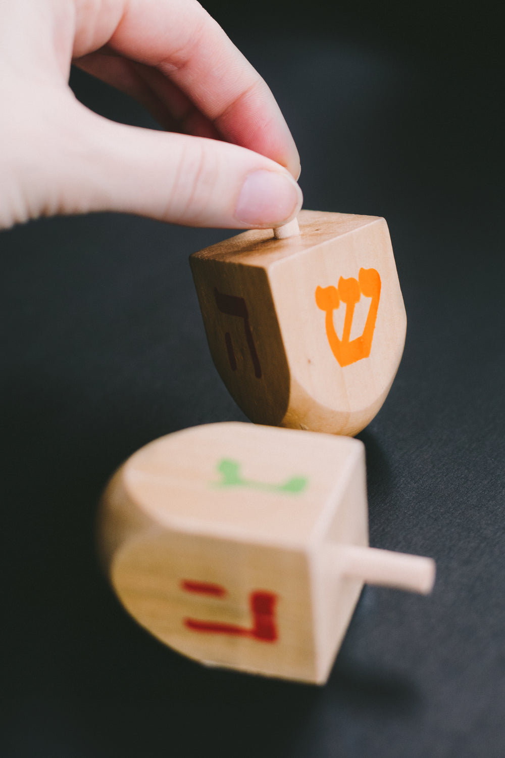 dreidel in hand