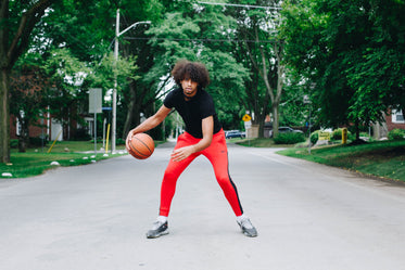 dribbling a basketball in the street