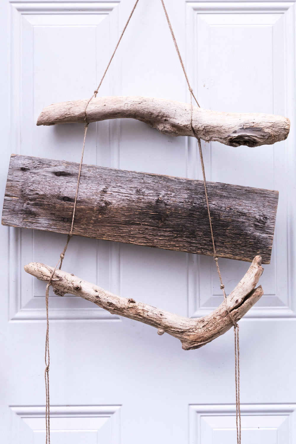 drift wood hanging on a white door