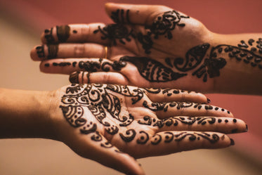 drying henna on persons palms