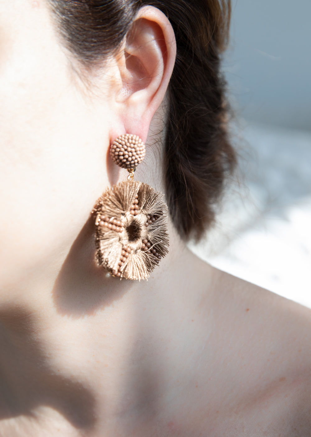ear close up with a light brown statement earring