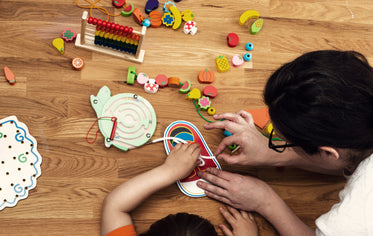 early childhood educator with toys and child