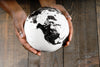 Person holding the world globe of the Earth on hand