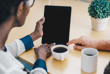 elderly hands holding ipad