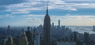 empire state building with clouds in distance