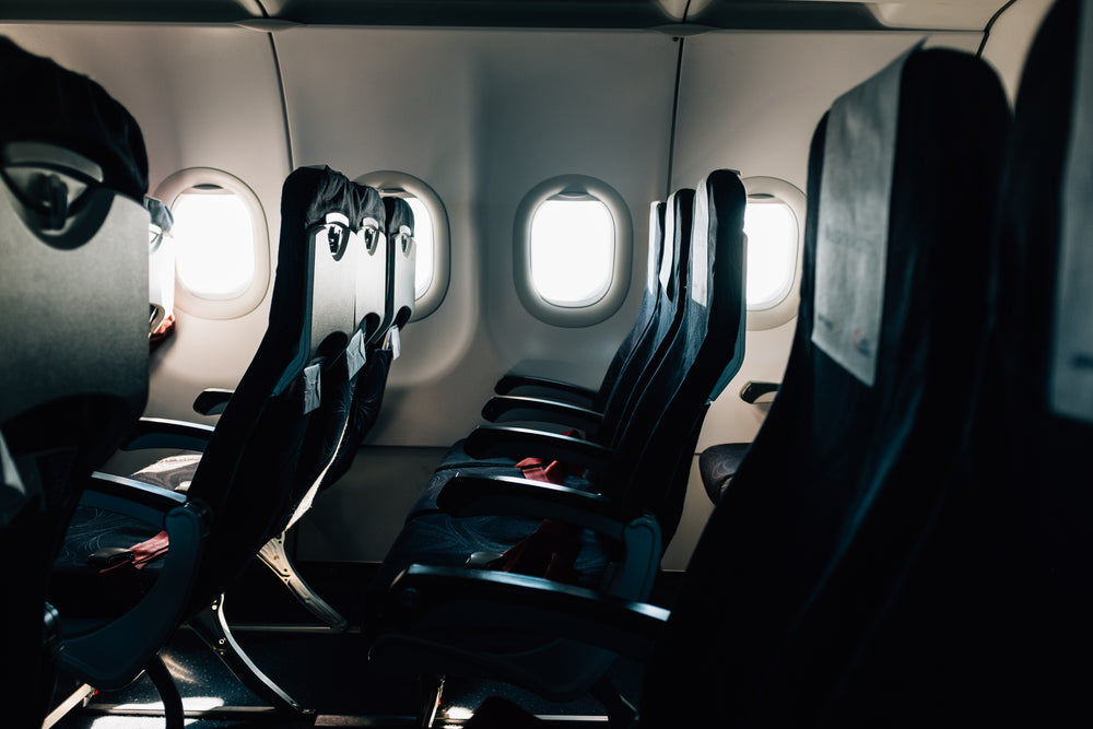 empty black seats on a commercial airplane