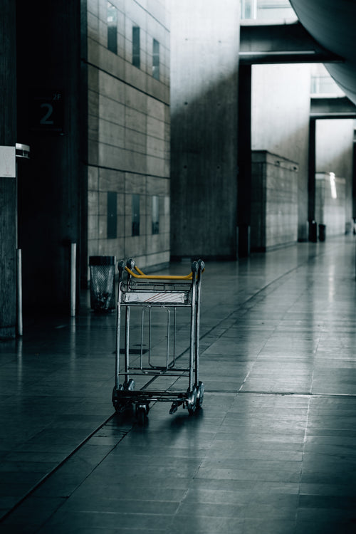 empty luggage cart in an industrial hallway