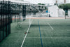 empty net on a green sports field in the city
