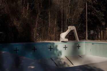empty swimming pool with slide in winter