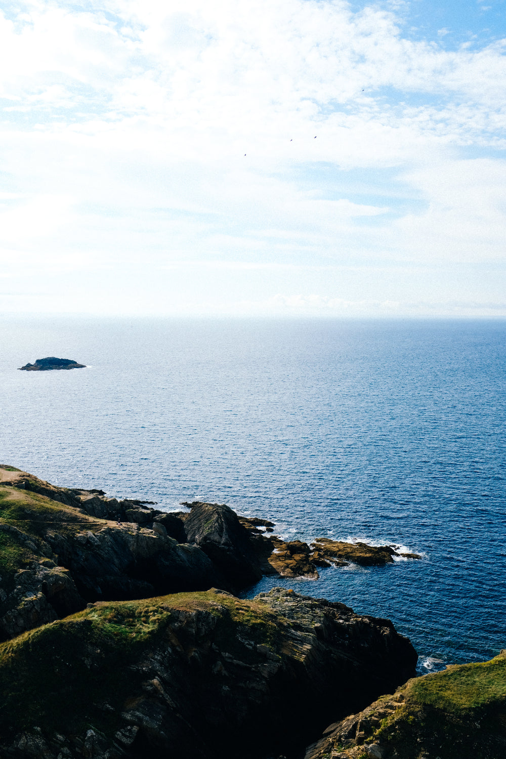 endless deep blue water and green hills