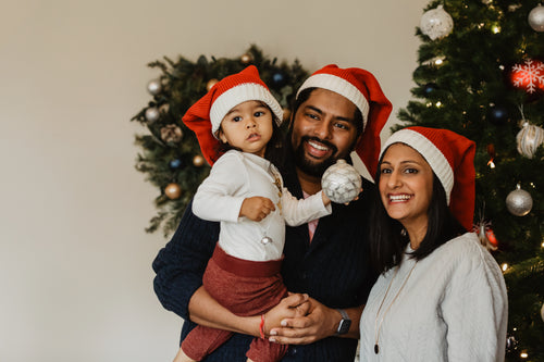family decorating christmas tree portrait