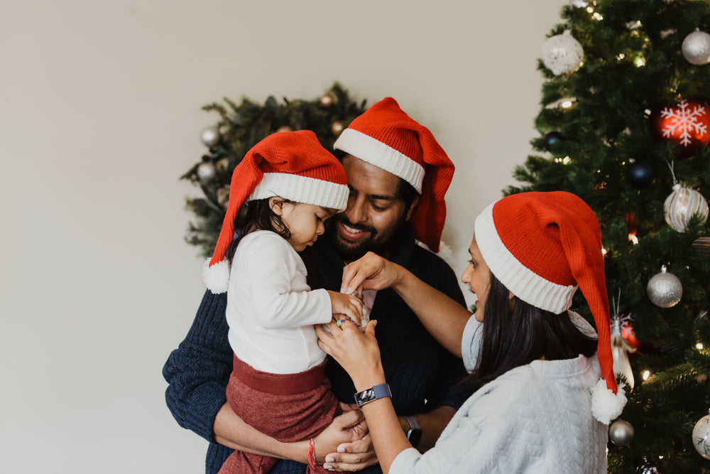 family decorating christmas tree