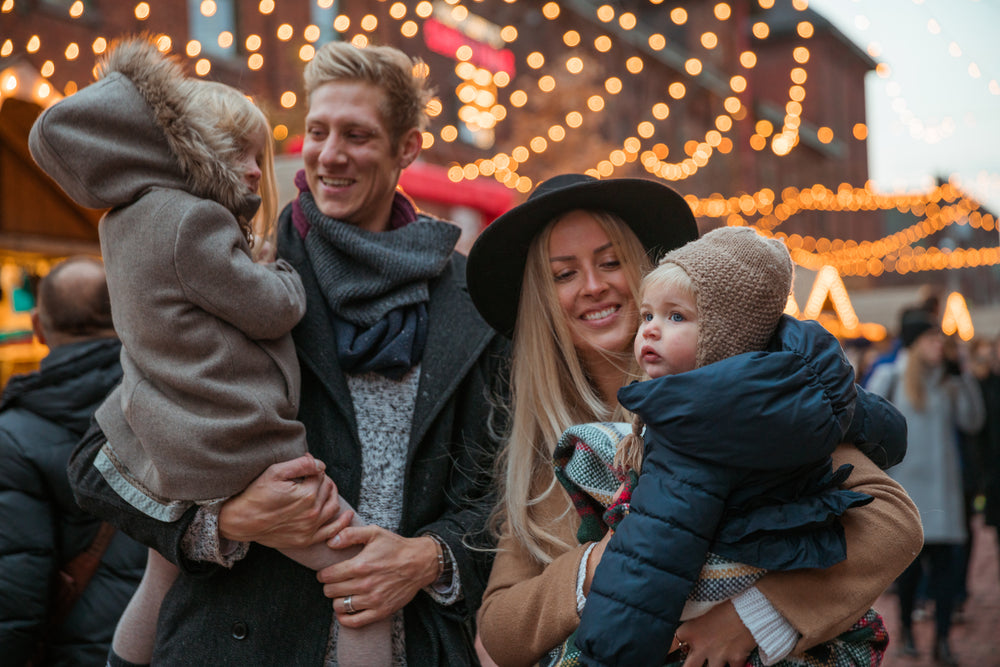 family in front of carousel