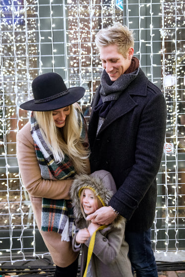 family laughing with holiday lights