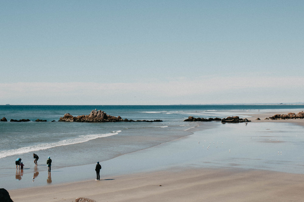 family taking photos by the sea