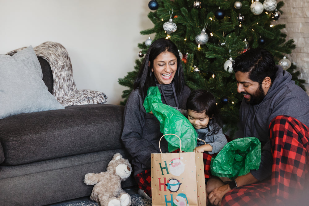 family unwrapping holiday gifts