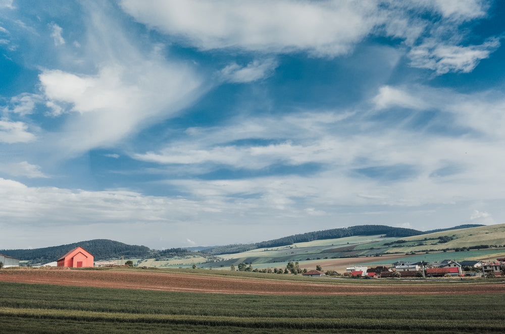 farmers fields with blue skies and white clouds