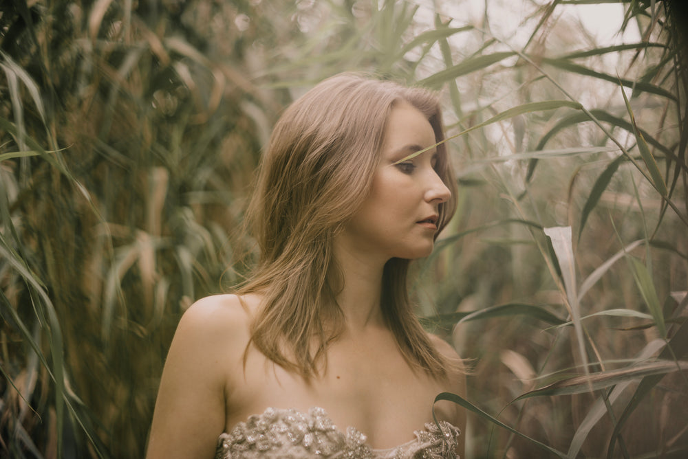 fashion model in beaded fashion and tall grass